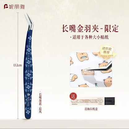 Blue curved craft tweezer with floral design, used for placing cute bear stickers.