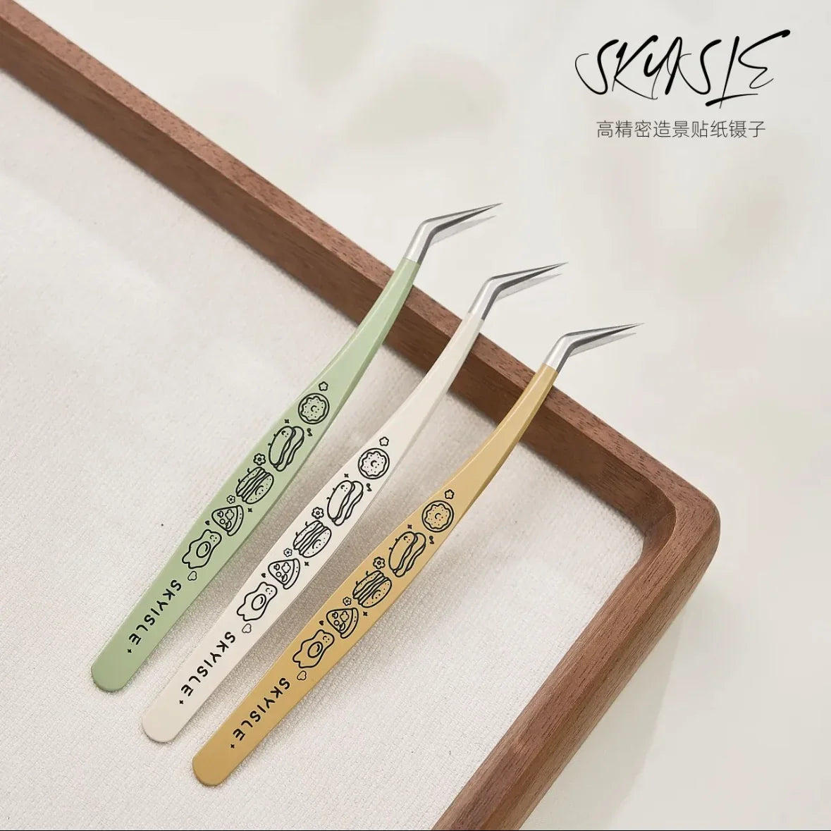 Three pastel precision tweezers with cute food designs, ideal for sticker crafting.