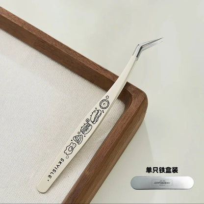 Cute precision tweezers with cartoon designs, angled tip, on wooden tray, for crafts