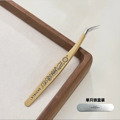 Yellow precision tweezer with cartoon designs and angled tip, ideal for crafting or sticker use