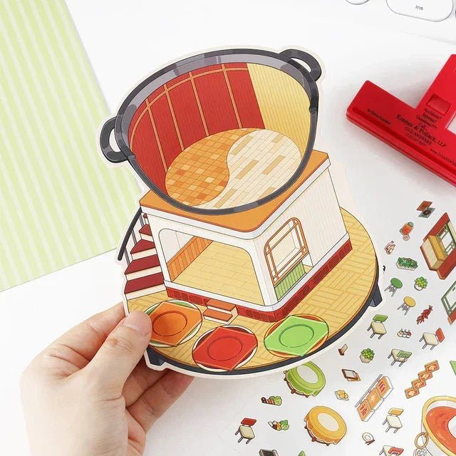Hand holding colorful hotpot-themed miniature scene sticker set with furniture and decor pieces