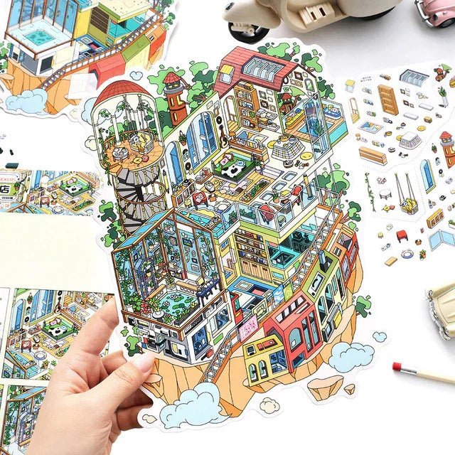 Hand holding colorful 3D miniature building scene sticker sheet for journaling or scrapbooking