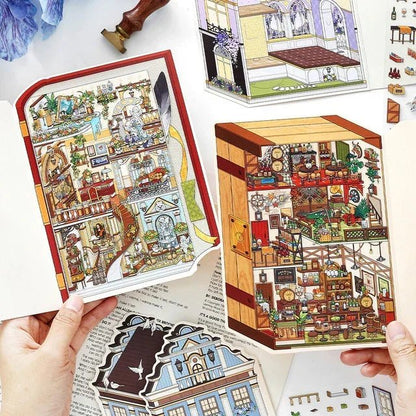 Hands holding cozy miniature European manor scene stickers with detailed rooms, perfect for journaling and scrapbooking.