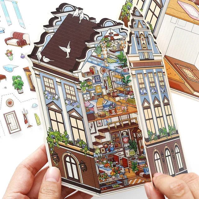 Hand holding European manor dollhouse sticker with cozy miniature room details for journaling