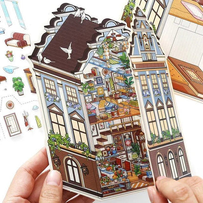 Hand holding European manor dollhouse sticker with cozy miniature room details for journaling