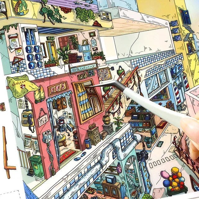 Colorful miniature city scene sticker with detailed cozy buildings and a hand using tweezers