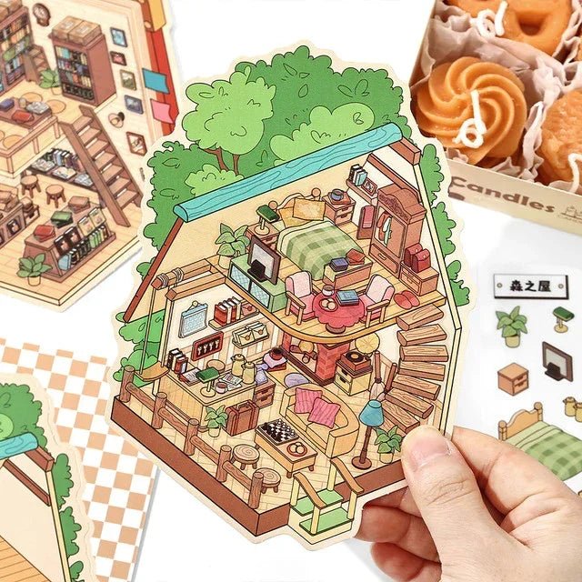 Hand holding a cozy miniature scene sticker of an A-frame house with cute interior decor.