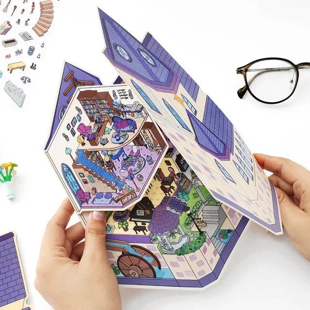 Hands holding a pop-up miniature witch castle scene sticker for journaling or scrapbooking