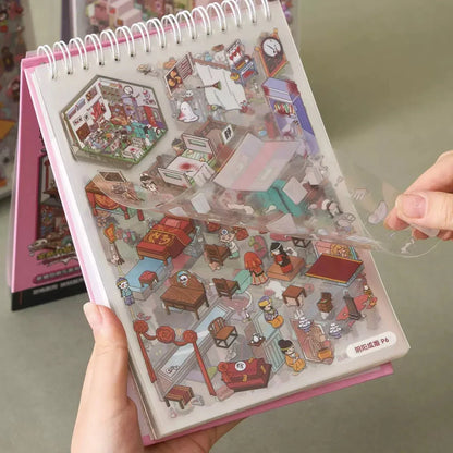 Hand flipping a clear sticker sheet with cute, detailed miniature horror town scenes for journaling.