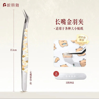 Long angled precision tweezers with gold and silver pattern, picking up small bear stickers.