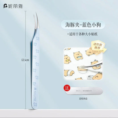Iridescent blue curved tip tweezers with puppy pattern, shown picking small stickers.