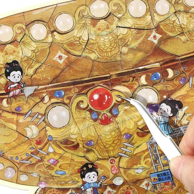 Hand using tweezers to peel cartoon restoration stickers from ornate golden jade bowl design