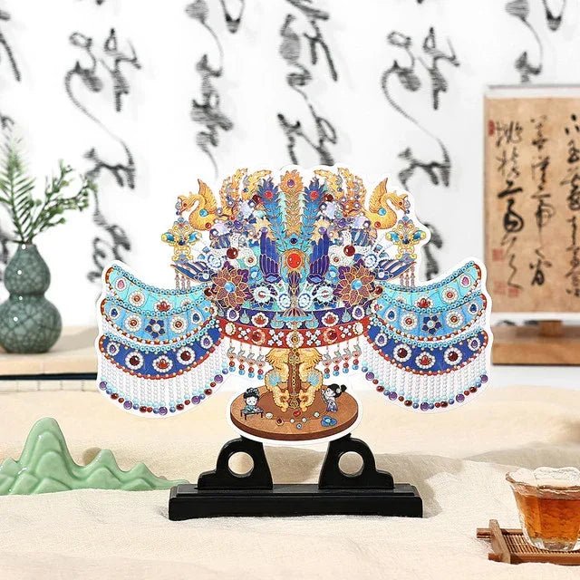 Intricate blue and white porcelain phoenix crown replica on display stand with traditional decor