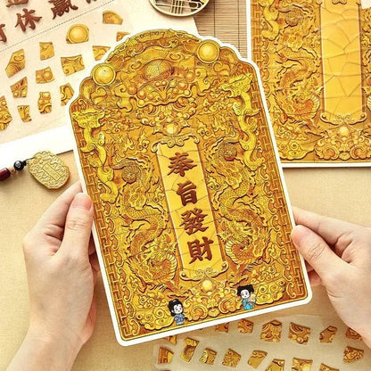 Hands holding ornate gold dragon sticker sheet, Asian-inspired for journaling or scrapbooking