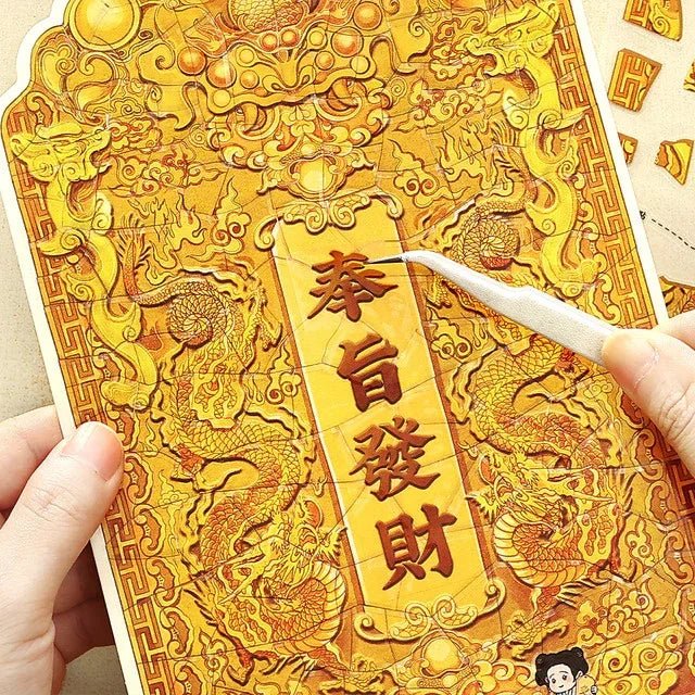 Hand holding ornate gold dragon sticker with Chinese characters, ideal for journaling or scrapbooking