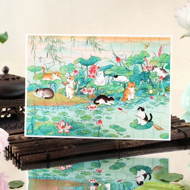 Sticker sheet featuring cats relaxing by a lotus pond with lily pads and pink lotus flowers.