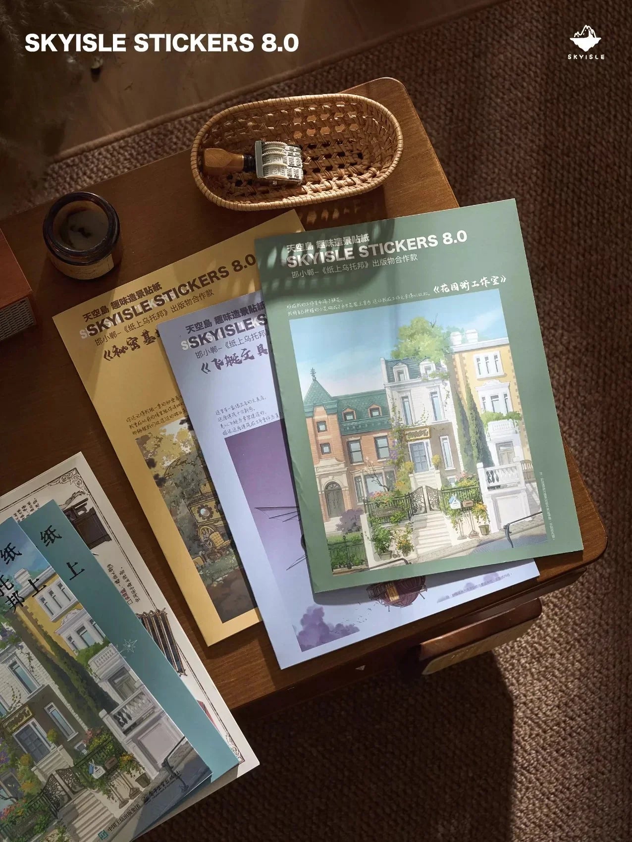 Architect sketch-style sticker sheets with whimsical house designs on a wooden table, cozy stationery setting.